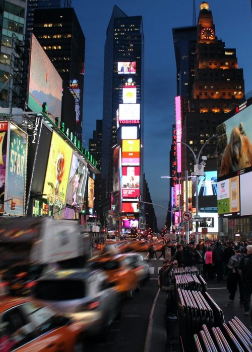 Times square at night with blurry traffic